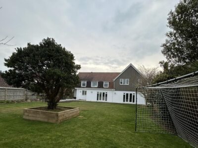 View from a large garden of a refurbished house with large side extension.