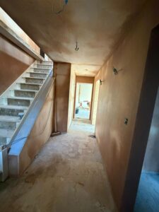 Work in progress, a new hall and stairs with plastered walls and bare steps