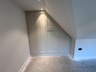 custom built storage in a loft conversion painted pale grey