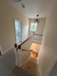 Newly finished hall stairs and landing, painted in cream